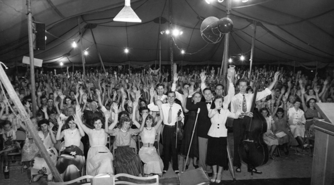Revival crowd — hands raised